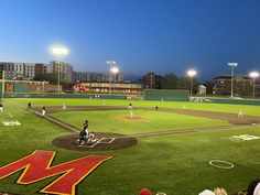 a baseball game is being played at night