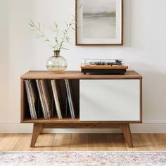 a record player sitting on top of a wooden cabinet