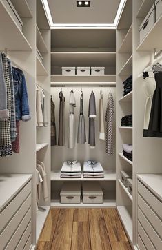 a walk in closet filled with lots of white drawers and clothes on top of shelves