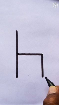 someone is writing the letter h on a piece of paper