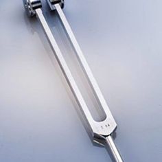 a pair of metal handles on top of a white table with blue and gray background