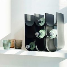 a number of vases and cups on a shelf