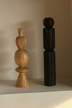 three wooden vases sitting on top of a shelf