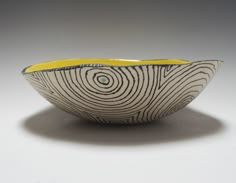 a white and yellow bowl sitting on top of a table