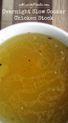 a white bowl filled with soup on top of a wooden table