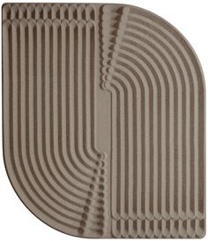 an oval shaped rug with wavy lines on it