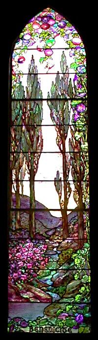 a stained glass window with trees and flowers