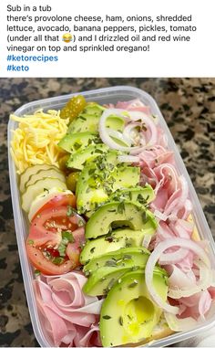 a plastic container filled with sliced vegetables and meats on top of a marble counter