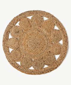 a round rug made out of jute on a white surface with circles in the middle