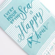 a towel with the words every hour, by the sea is happy to have