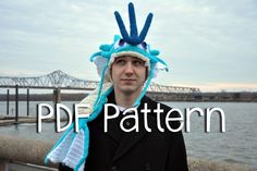 a man wearing a blue and white knitted hat with the words pdd pattern on it