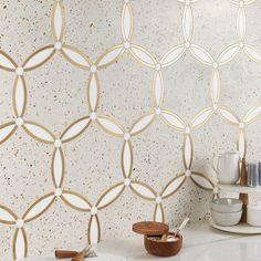 a white sink sitting under a mirror next to a wall mounted faucet in a bathroom