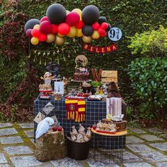 a table topped with lots of food and balloons