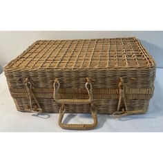 an old wicker trunk with two handles