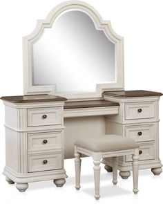 an antique white vanity with mirror and stool