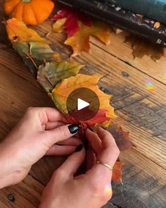 someone is making a fall leaf garland on the table