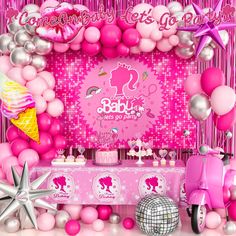 a pink baby shower with balloons and decorations