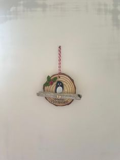 a christmas ornament hanging from the side of a wall with a bird on it