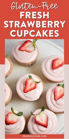 strawberry cupcakes with frosting and fresh strawberries on top, sitting on a white plate