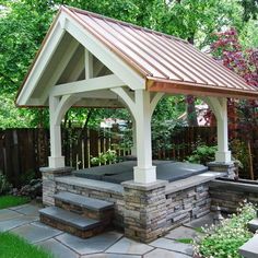 an outdoor hot tub in the middle of a garden