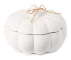 a white pumpkin shaped box with a string tied around the top on a white background