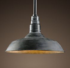 an industrial style pendant light hanging from a ceiling fixture in a kitchen or dining room