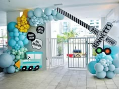 an entrance decorated with balloons and street signs