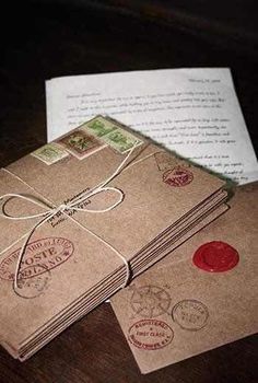 two brown envelopes with stamps on them