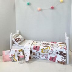 a small child's bed with a white headboard and foot board next to it