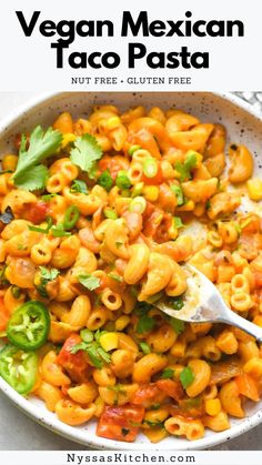 a white bowl filled with macaroni and cheese, garnished with cilantro