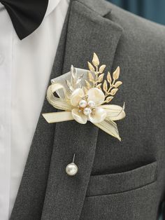 a man in a suit with a boutonniere and pearl brooch on his lapel