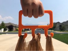 a person holding two bags in front of their face with one hand and the other behind them