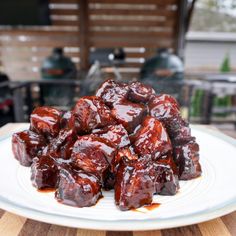 a white plate topped with meat covered in sauce