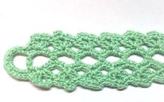 the crochet pattern is green and has two holes for each stitch to be sewn together