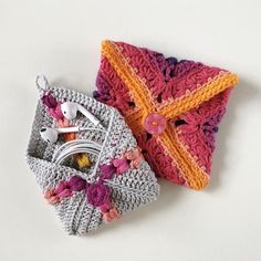 two crocheted items sitting next to each other on top of a white surface