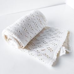 two white crocheted towels folded on top of each other