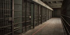 the inside of a jail cell with bars and doors