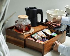 a person sitting at a table with some tea and snacks in front of them,