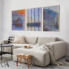 a living room with three paintings on the wall