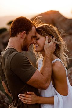 a man and woman embracing each other in the desert