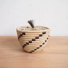 a woven basket sitting on top of a wooden table