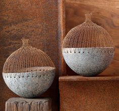 two vases sitting on top of wooden blocks