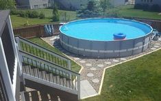 an above ground swimming pool with steps leading up to it and a deck in the middle