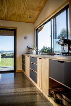 an open kitchen with lots of counter space next to a sliding glass door that leads outside