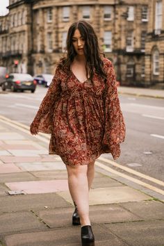 Get ready to fall in love with this paisley chiffon smock dress. We've taken our Tattoo Smock Dress and improved the fit, perfecting the shape at the bust for a more universal and comfortable shape. The mega flared sleeves and rust paisley fabric with subtle metallic thread bring a retro vibe that's impossible to resist. This dress is your new go-to for effortless boho style through all the seasons.  Lined through body with sheer flared sleeves, tie back detail and side zip closure. 100% Polyester  Machine wash at 30°C Paisley Fabric, Brand Magazine, Gold Dust, Kimono Dress, Metallic Thread, Smock Dress, Retro Vibe, Independent Designers Fashion, Flared Sleeves