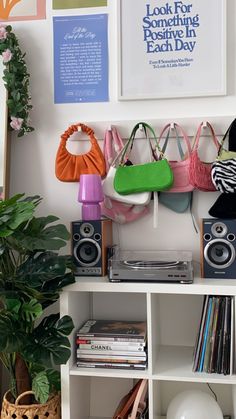 there are many purses and books on the shelf next to each other in this room