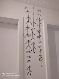 the wall is decorated with black and white flowers