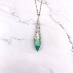 This elegant yet whimsical pendulum necklace is perfect for any witch, spiritualist, or divination enthusiast. The pendant features a beautiful green resin pendulum, measuring 2.25" x .50 inches. It is suspended from an 18-inch nickel-free chain. This necklace is not only beautiful, but it can also be used as a functional pendulum for divination. Pendulums are used to answer questions, make decisions, and connect with the divine. The Green Resin Pendulum Necklace is a powerful tool for self-disc Pendulum Necklace, Desired Reality, The Divine, Free Giveaway, Witch, Pendant Necklace, Chain, Pendant, Green