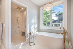 a white bath tub sitting next to a window