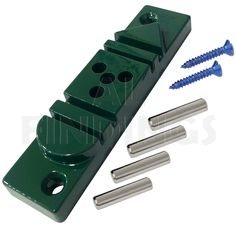 an assortment of screws and nuts in front of a green plastic holder with four holes